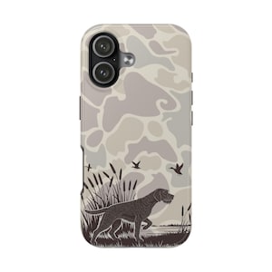 May include: A phone case with a camouflage pattern in shades of gray and beige. The case features a detailed illustration of a hunting dog in front of a marsh scene with flying ducks and cattails.