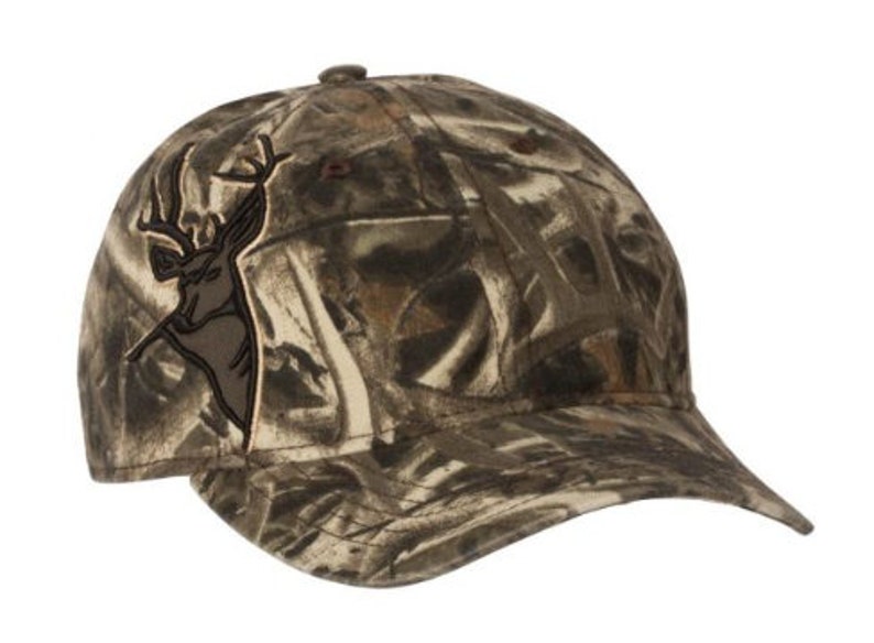 May include: A camouflage baseball cap with a brown deer silhouette embroidered on the front.
