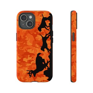 May include: Orange and black camouflage phone case with a silhouette of a deer and three dogs running.