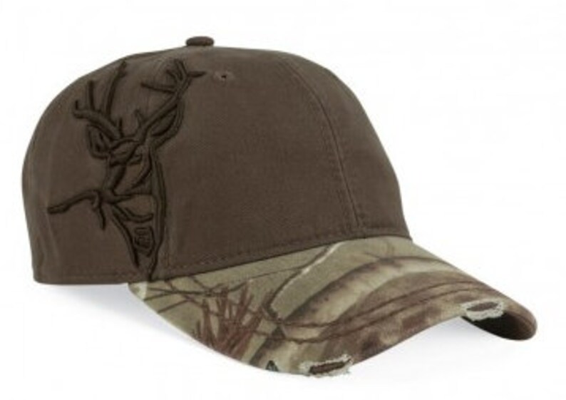May include: A brown baseball cap with a camouflage brim and a deer head embroidered on the front.