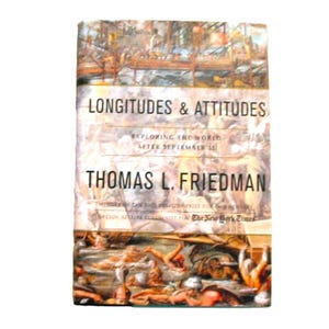 May include: A hardcover book titled "Longitudes & Attitudes" by Thomas L. Friedman. The cover features an illustration with figures and a bridge. The text "Exploring the World After September 11" is also visible.