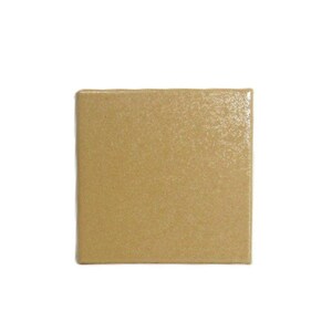 May include: A square, tan-colored ceramic tile with a textured surface. The tile is set against a white background, highlighting its shape and color. The tile's edges are slightly rounded.