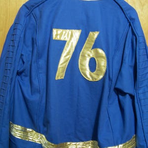 May include: A blue jacket with gold trim and the number 76 on the back.
