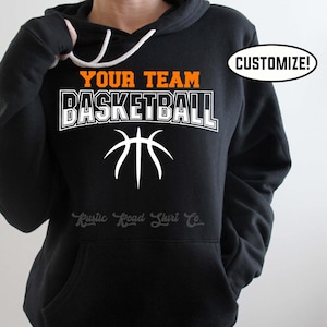 May include: Black hoodie with an orange and white basketball graphic and the text "Your Team Basketball".