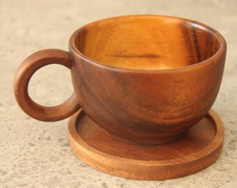 Coffee cup made of dark acacia wood with a small coaster