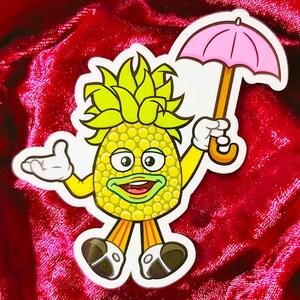 May include: A cartoon pineapple character with a yellow and green body, wearing orange pants and black shoes, holding a pink umbrella. The character is smiling and has a friendly expression.