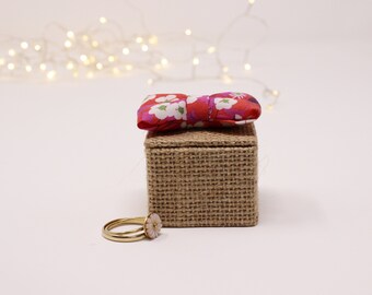 small box square wedding rings in jute, red liberty knot, white linen interior