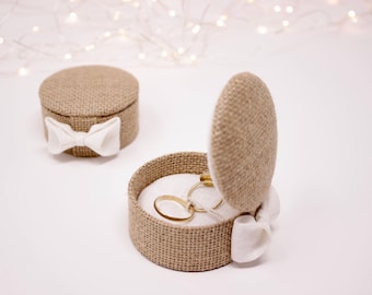 Delicate burlap and white linen ring bearer.