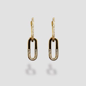 May include: A pair of gold-colored link earrings. Each earring features a long, slender top section and a larger, oval-shaped link. The links are adorned with small, sparkling stones, adding a touch of elegance to the jewelry.