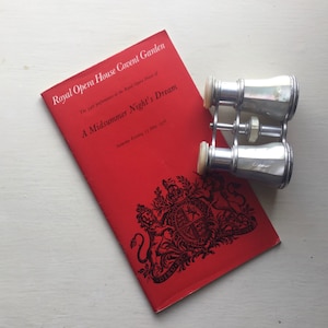 May include: A red programme for a performance of A Midsummer Night's Dream at the Royal Opera House Covent Garden. The programme features the Royal Coat of Arms and the date Saturday Evening, 15 May 1971.