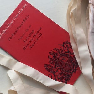 以下が含まれることがあります： ロイヤル・オペラ・ハウス・コヴェント・ガーデンでのロイヤル・デンマーク・バレエの公演の赤いプログラム。プログラムには、「ラ・シルフィード」、「奇跡のマンダリン」、「ナポリ第3幕」のバレエ公演が記載されています。