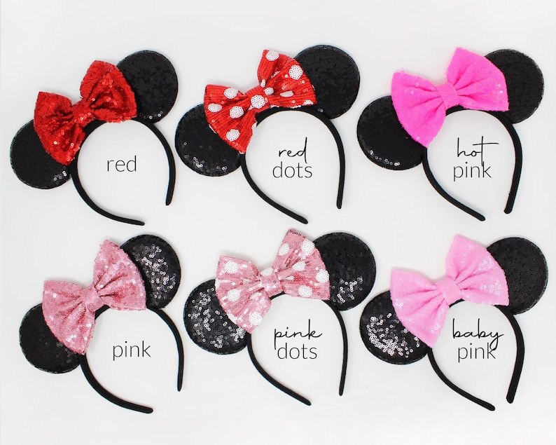 May include: Six headbands with black sequined ears and fabric bows in various colors and patterns. The bows are labeled red, red dots, hot pink, pink, pink dots, and baby pink. Each headband features a thin black band and round ears.