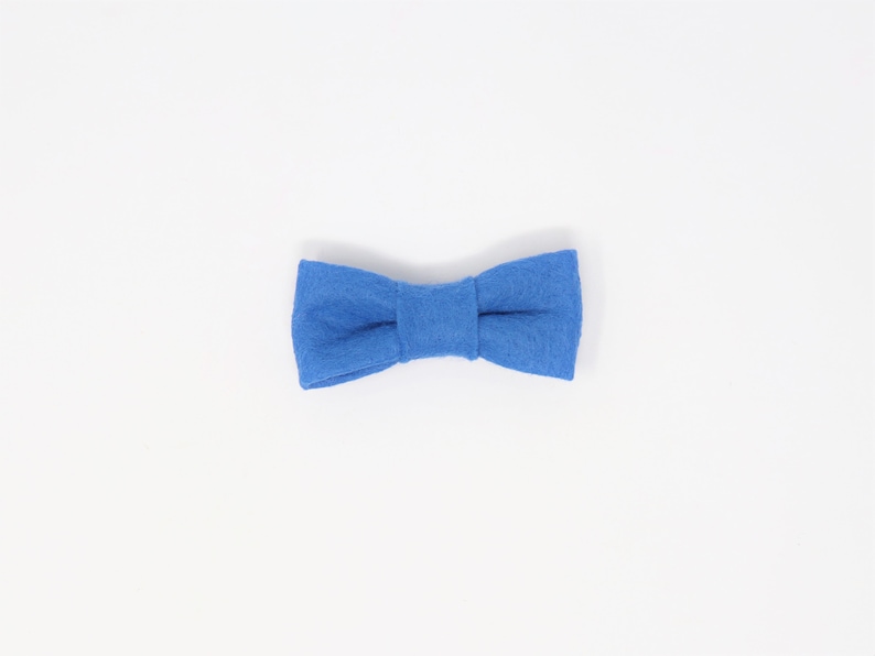 May include: A blue felt bow tie.
