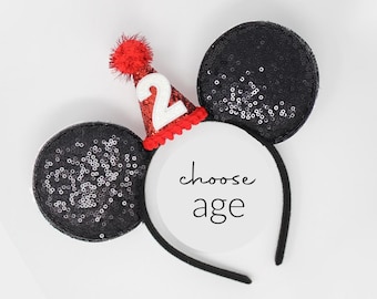May include: Black sequin Mickey Mouse ears headband with a red and white birthday hat with the number 2 on it. Choose age.