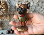 French bulldog doll on wooden stand