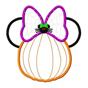May include: A purple and white bow with a spider web design and a black spider in the center. The bow is attached to a pumpkin-shaped headband with orange and white stripes.