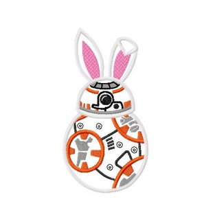 May include: A white and orange robot with pink bunny ears. The robot has a round body with a circular design on the front.