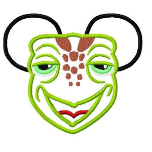 May include: Green cartoon turtle face with brown spots and large black ears. The turtle is smiling with a red mouth.