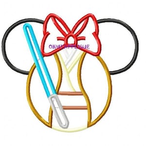 May include: A red bow with a white and gold baseball with a blue lightsaber behind it. The baseball has a brown and white stitching. The baseball is inside of a pair of black mouse ears.