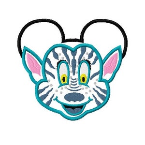 May include: An embroidered patch featuring a cartoon character with a zebra-striped face, blue ears, and black mouse ears. The character has a wide smile and yellow eyes.
