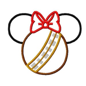 May include: A red bow with a brown and gold circle with a white and gold stripe pattern. The circle has two black mouse ears on the sides.