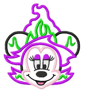 May include: Purple and green cartoon character with large eyes and a big smile. The character has a witch hat with a green flame design.