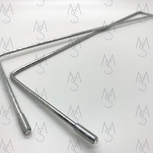 May include: Two silver metal bent wire frames with rounded ends. The frames are stacked on top of each other.