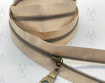 Antique Brass Nylon Coil Zipper (#3 Size) with Beige Tape & Antique Brass Pulls - Zipper by the Yard - Nylon Coil Zipper - Metallic Zipper