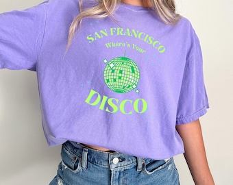 May include: Purple t-shirt with a green and white disco ball graphic and the text "San Francisco Where's Your Disco".