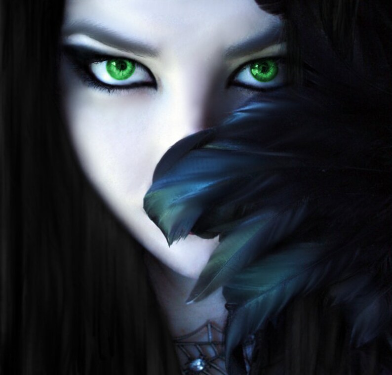May include: A digital art portrait of a person with striking green eyes and dark hair. A cluster of black and teal feathers partially obscures the face. The image has a fantasy or gothic theme.