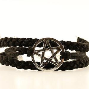 May include: A black braided leather bracelet with a silver pentagram charm.