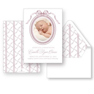 May include: A pink and white baby announcement card with a photo of a baby girl sleeping in a white oval frame. The text reads "Joyfully Announcing Camille Ryan Owens Born on September 23, 2014 weighing 7 pounds 4 ounces, measuring 21 inches long."