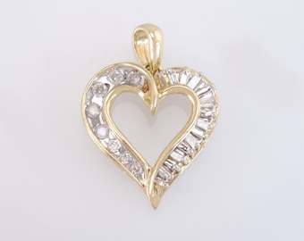 May include: A gold pendant in the shape of a heart, adorned with round and baguette-cut diamonds. The pendant has a bail for attaching to a chain. The diamonds are set in a white metal, creating a contrast with the gold.