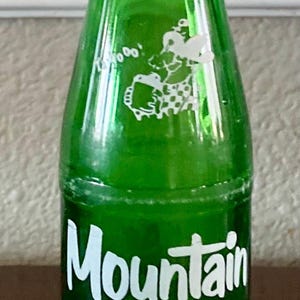 Vintage 1965 10oz. Mountain Dew &quot;Laughing Pig&quot; Soda Pop Bottle - &quot;It&#39;ll Tickle Your Innards&quot; - Hillbilly Style - Retired