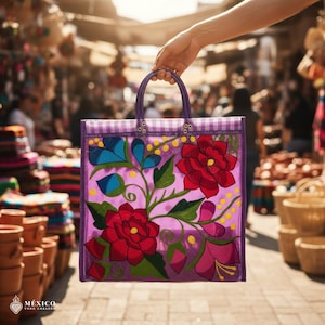 May include: A purple tote bag with a floral design. The bag features large red flowers, blue accents, and green leaves. The top edge has a checkered pattern. The bag is held by a hand in a market setting.