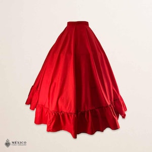 May include: A vibrant red full-length skirt featuring a high waistband and a voluminous, pleated silhouette. The hem is finished with a wide, gathered ruffle detail that adds texture and movement to the solid-colored garment.