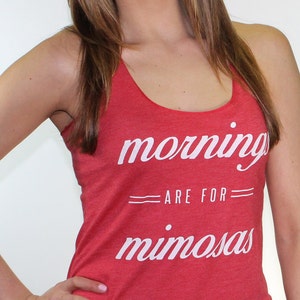 May include: Red tank top with the text "mornings are for mimosas" in white lettering.