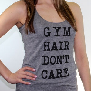 May include: Gray tank top with the text "GYM HAIR DON'T CARE" printed in black.