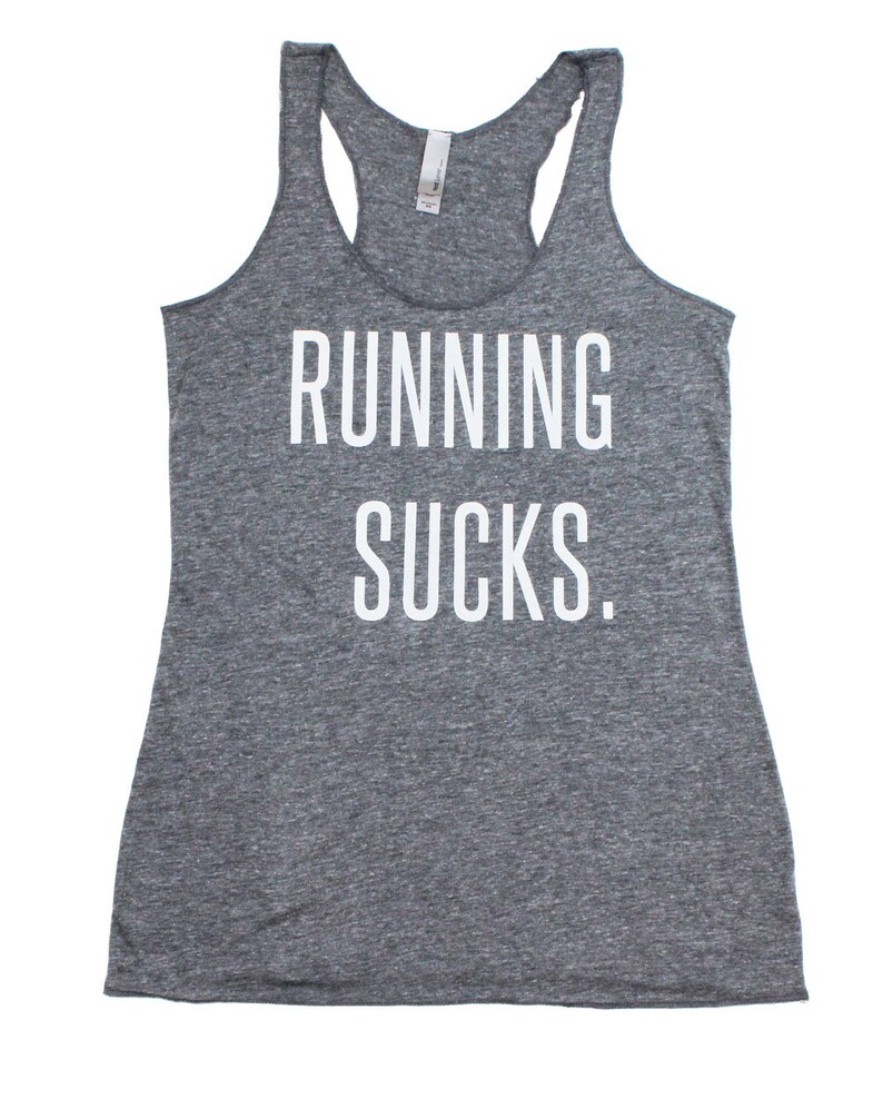 May include: Gray tank top with the text "RUNNING SUCKS." printed in white.