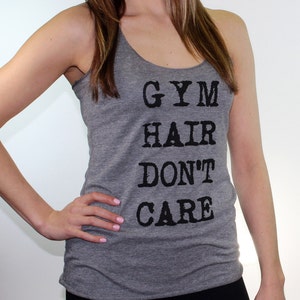 May include: Gray tank top with the text "GYM HAIR DON'T CARE" printed in black.