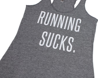 May include: Gray tank top with the text "RUNNING SUCKS." printed in white.