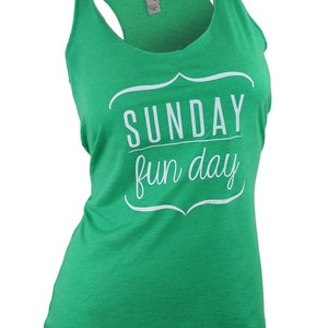 May include: Green tank top with a white graphic that says "SUNDAY fun day" in a decorative frame.