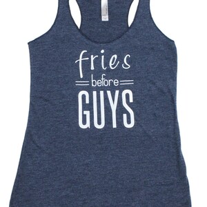 May include: A navy blue tank top with the text "fries before guys" printed in white.