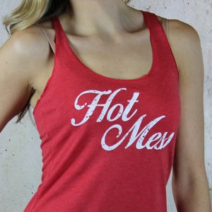 May include: Red tank top with a white graphic that says "Hot Mess".