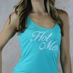 May include: A turquoise tank top with the words "Hot Mess" printed in white on the front.