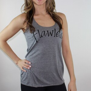 May include: Gray tank top with the word "flawless" written in black cursive script.