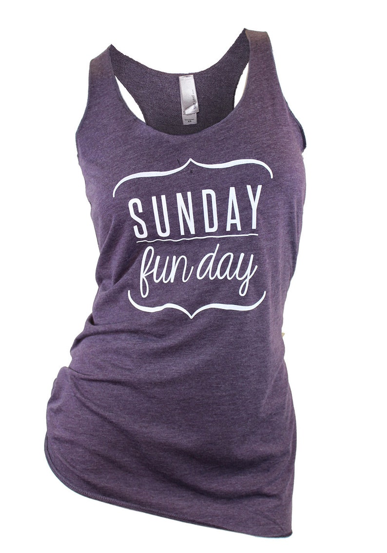 Op de afbeelding: Paars tanktop met een witte afbeelding met de tekst "SUNDAY fun day" in een decoratief lettertype.