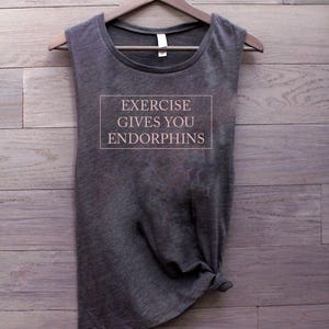 May include: Gray sleeveless tank top with the text "EXERCISE GIVES YOU ENDORPHINS" printed on the front.