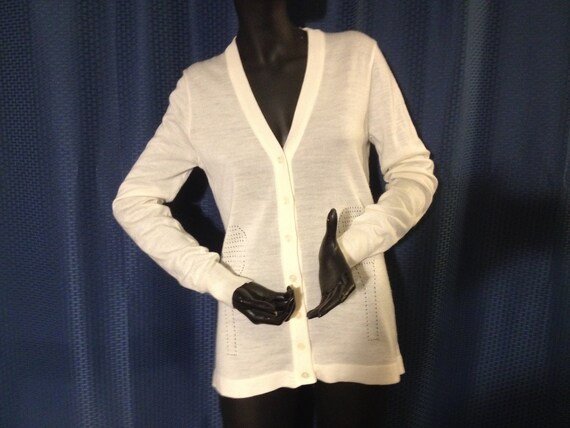 white tennis sweater