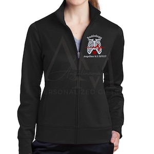 May include: Black zippered jacket with a white embroidered design of a ribcage with a heart and EKG line. The text "Radiology" and "Angelina R.T. (R)(CT)" is embroidered below the design.